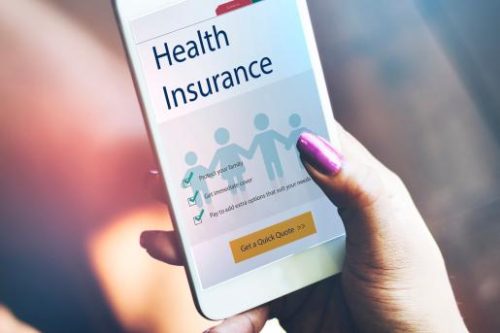 Woman holding a cell phone looking at health insurance prior authorizations for her pharmacy in Idaho Falls, Rocky Mountain Pharmacy